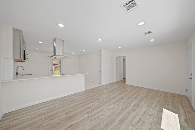 5763 Belneath St, Houston, TX 77033 - unfurnished living room featuring a sink, light wood finished floors, recessed lighting, and baseboards