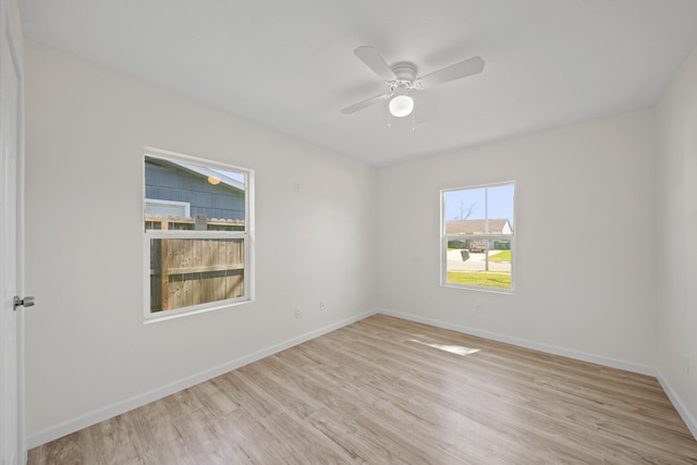 5763 Belneath St, Houston, TX 77033 - empty room featuring light wood finished floors, baseboards, and ceiling fan