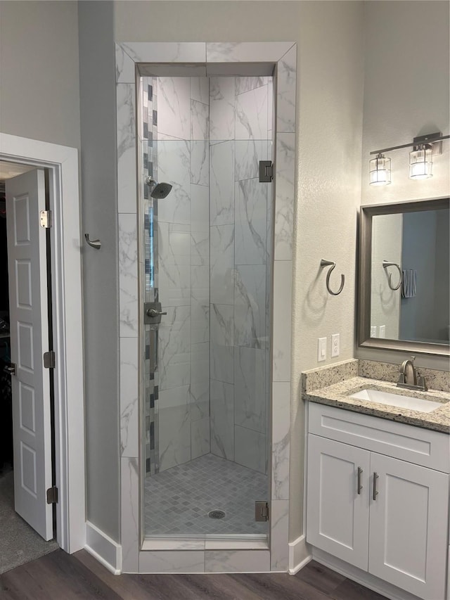 170 Nuuanu Ln, Bastrop, TX 78602 - full bath featuring a stall shower, wood finished floors, baseboards, and vanity