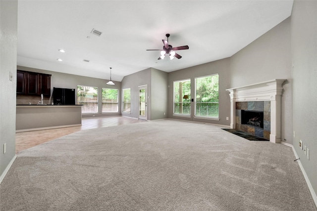 27506 Colin Springs Ln, Spring, TX 77386 - unfurnished living room featuring baseboards, ceiling fan, light colored carpet, and lofted ceiling