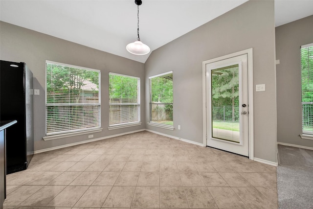 27506 Colin Springs Ln, Spring, TX 77386 - unfurnished dining area with healthy amount of natural light, vaulted ceiling, baseboards, and light tile patterned flooring