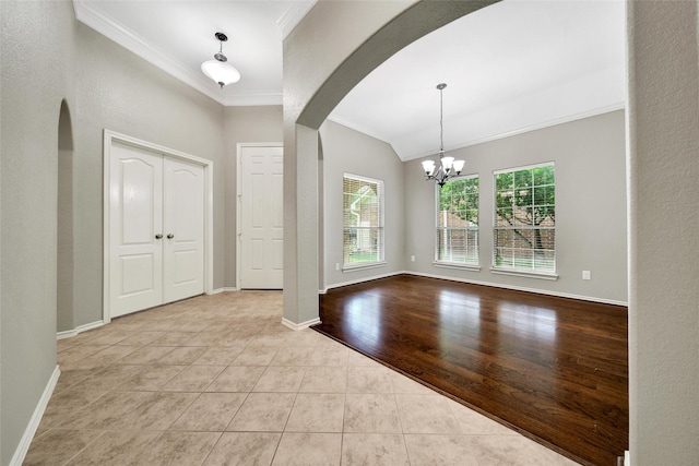 27506 Colin Springs Ln, Spring, TX 77386 - tiled foyer entrance featuring arched walkways, ornamental molding, plenty of natural light, lofted ceiling, and a chandelier