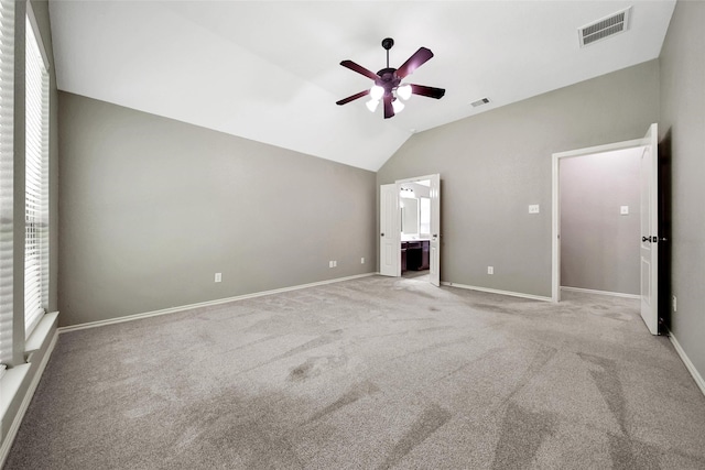 27506 Colin Springs Ln, Spring, TX 77386 - unfurnished bedroom with vaulted ceiling, light colored carpet, baseboards, and ensuite bath