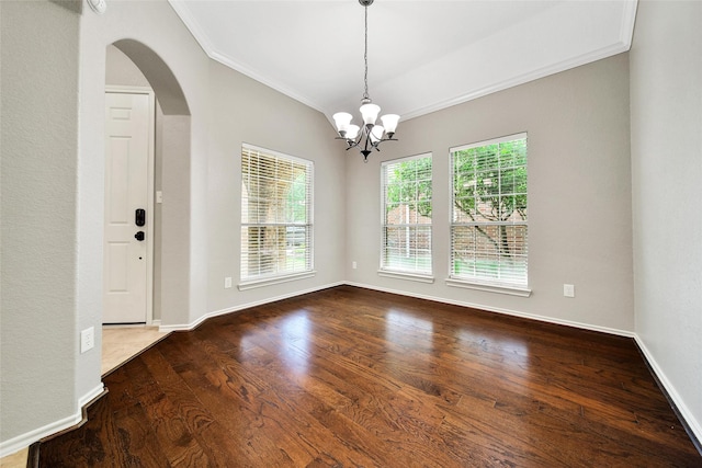 27506 Colin Springs Ln, Spring, TX 77386 - unfurnished dining area with crown molding, arched walkways, a chandelier, wood finished floors, and baseboards