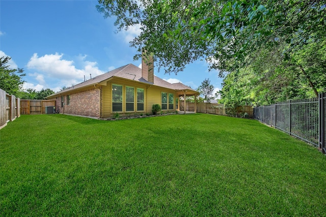 27506 Colin Springs Ln, Spring, TX 77386 - rear view of house featuring a chimney, brick siding, and central AC unit