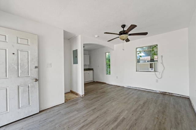 1922 Des Jardines St, Houston, TX 77023 - entryway featuring cooling unit, ceiling fan, arched walkways, and wood finished floors