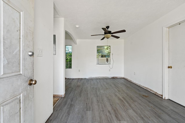 1922 Des Jardines St, Houston, TX 77023 - spare room featuring arched walkways, wood finished floors, a ceiling fan, cooling unit, and a textured ceiling