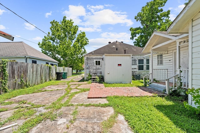 1922 Des Jardines St, Houston, TX 77023 - view of yard featuring fence, an outdoor structure, a storage shed, and central air condition unit