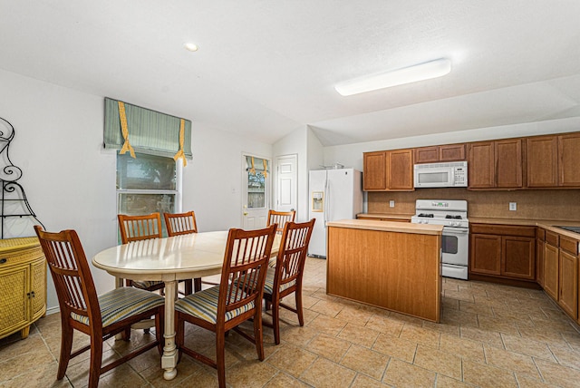 22327 Albee Dr, Katy, TX 77449 - kitchen with white appliances, a center island, stone tile flooring, brown cabinetry, and recessed lighting
