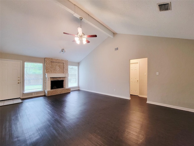6722 Loch Bruceray Dr, Houston, TX 77084 - unfurnished living room with dark wood-type flooring, beamed ceiling, ceiling fan, baseboards, and a brick fireplace