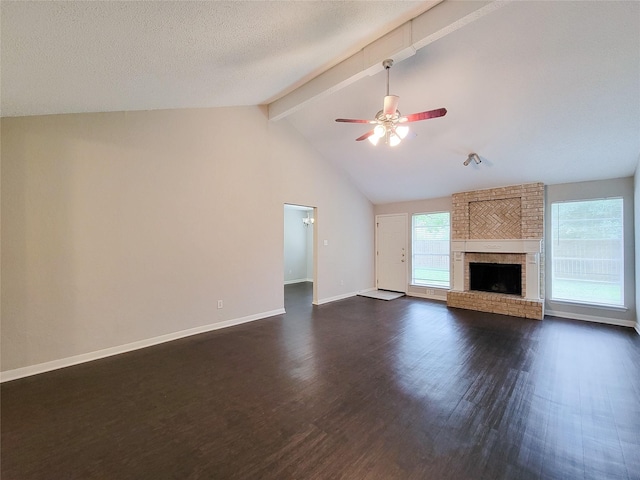 6722 Loch Bruceray Dr, Houston, TX 77084 - unfurnished living room featuring beam ceiling, dark wood-style flooring, a ceiling fan, baseboards, and a fireplace