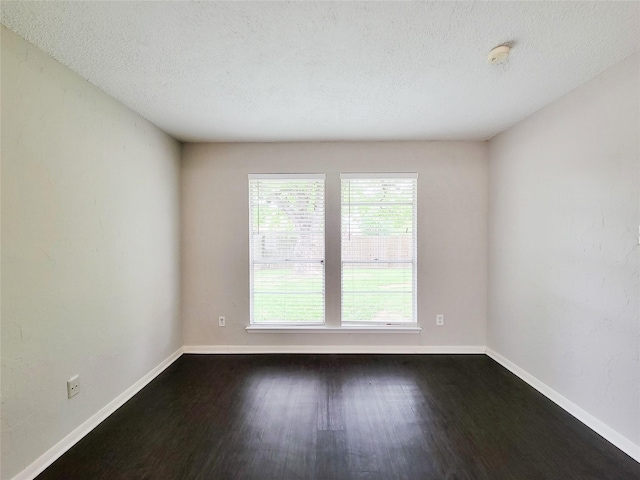 6722 Loch Bruceray Dr, Houston, TX 77084 - spare room with a smoke detector, baseboards, dark wood finished floors, and a textured ceiling