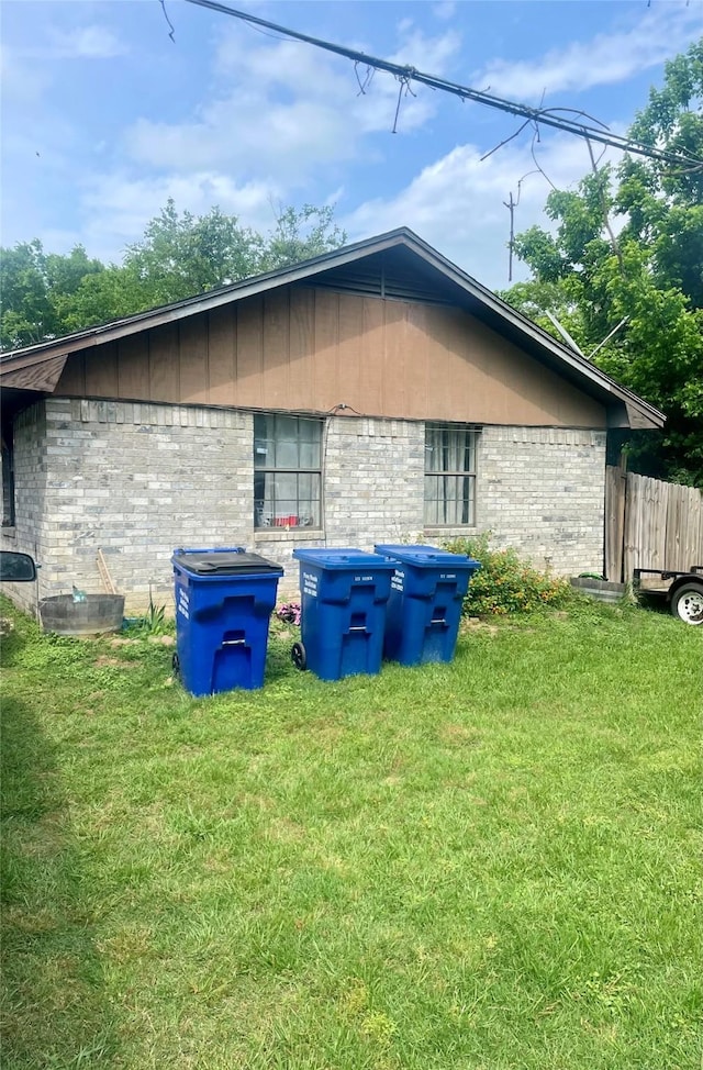 111 Sowescor St, Crockett, TX 75835 - view of side of home featuring brick siding and a yard