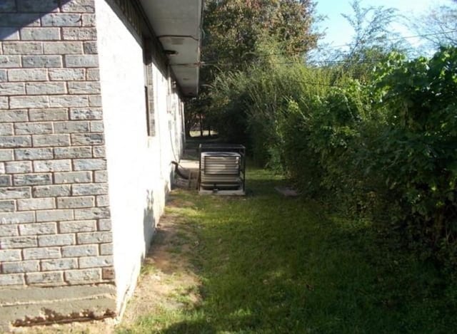 111 Sowescor St, Crockett, TX 75835 - view of side of property featuring brick siding and cooling unit