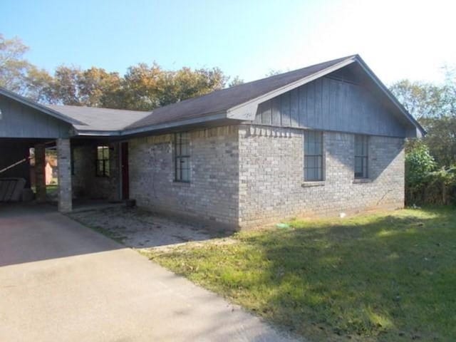 111 Sowescor St, Crockett, TX 75835 - view of home's exterior with a yard, brick siding, and driveway
