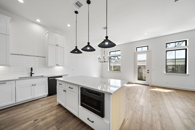 1706 Sedola Ln, Houston, TX 77055 - kitchen with dishwasher, a sink, light wood-style floors, decorative backsplash, and light stone counters