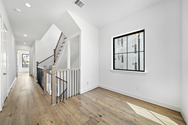 1706 Sedola Ln, Houston, TX 77055 - hall featuring hardwood / wood-style floors, baseboards, an upstairs landing, and recessed lighting