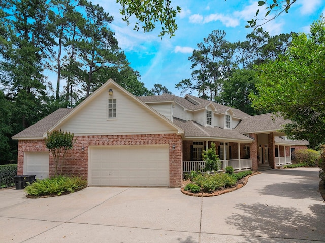 23222 Red Oak Trl, Tomball, TX 77377 - traditional-style house with brick siding, a porch, driveway, roof with shingles, and a garage