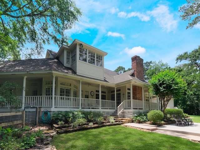 23222 Red Oak Trl, Tomball, TX 77377 - view of front of home with covered porch, a chimney, a front lawn, and roof with shingles