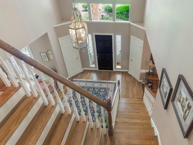 23222 Red Oak Trl, Tomball, TX 77377 - foyer entrance with a towering ceiling, healthy amount of natural light, wood finished floors, stairway, and a chandelier