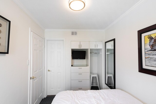 6102 Seawall Blvd Unit 140, Galveston, TX 77551 - bedroom featuring ornamental molding and a closet