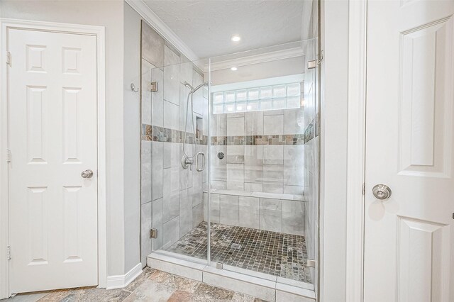 11607 Knobcrest Dr, Houston, TX 77070 - bathroom featuring crown molding, a stall shower, and baseboards