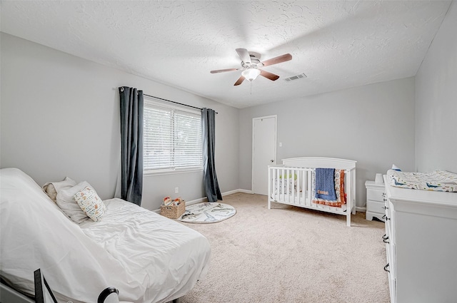 11607 Knobcrest Dr, Houston, TX 77070 - bedroom with light carpet, a textured ceiling, a ceiling fan, and baseboards