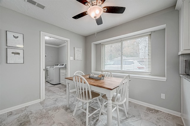 11607 Knobcrest Dr, Houston, TX 77070 - dining space featuring washing machine and clothes dryer, light marble finish floors, baseboards, and ceiling fan