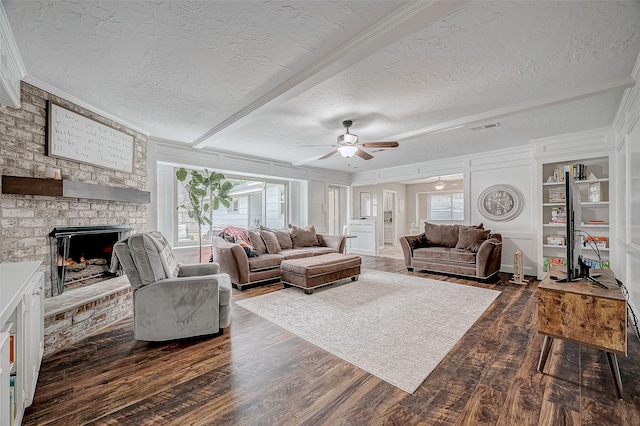 11607 Knobcrest Dr, Houston, TX 77070 - living area featuring ceiling fan, dark wood-type flooring, a fireplace, a textured ceiling, and ornamental molding