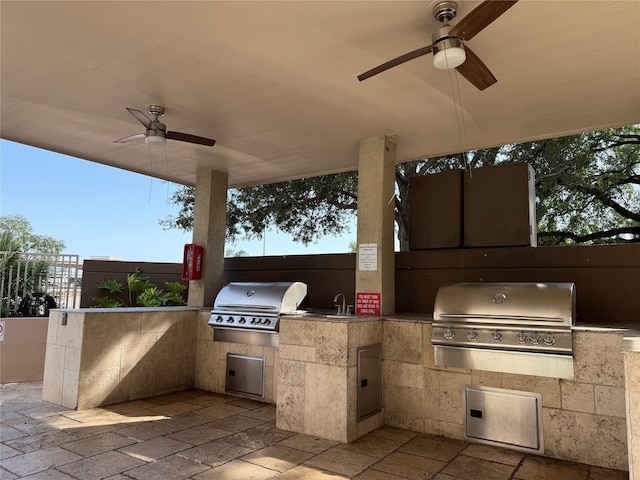 view of patio with a ceiling fan, area for grilling, and a grill