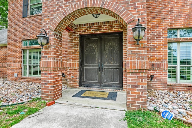 property entrance featuring brick siding