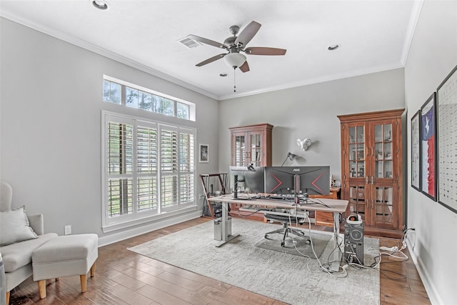 office space with ceiling fan, wood finished floors, ornamental molding, and baseboards