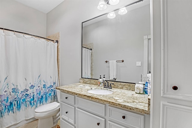 bathroom featuring toilet, vanity, and curtained shower
