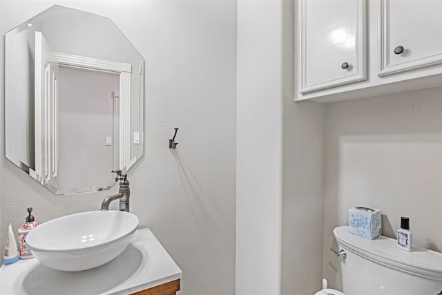 bathroom with toilet and vanity