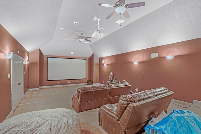 carpeted cinema room featuring ceiling fan, lofted ceiling, and baseboards