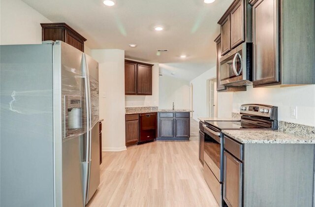 2037 Mule Rdg, Katy, TX 77493 - kitchen featuring stainless steel appliances, light wood-type flooring, recessed lighting, light stone countertops, and a sink