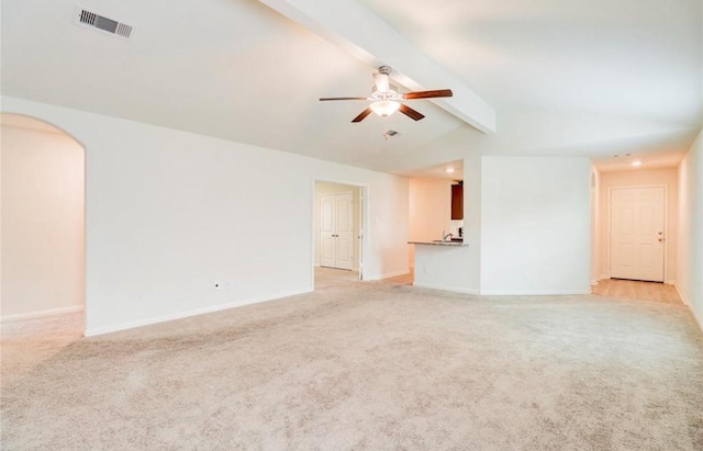 2037 Mule Rdg, Katy, TX 77493 - unfurnished living room featuring light carpet, ceiling fan, arched walkways, and baseboards