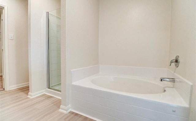 2037 Mule Rdg, Katy, TX 77493 - bathroom with a shower stall, wood finished floors, a bath, and baseboards