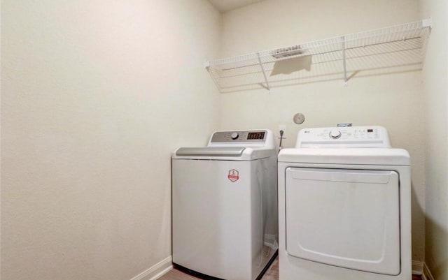 2037 Mule Rdg, Katy, TX 77493 - clothes washing area featuring washer and clothes dryer and baseboards