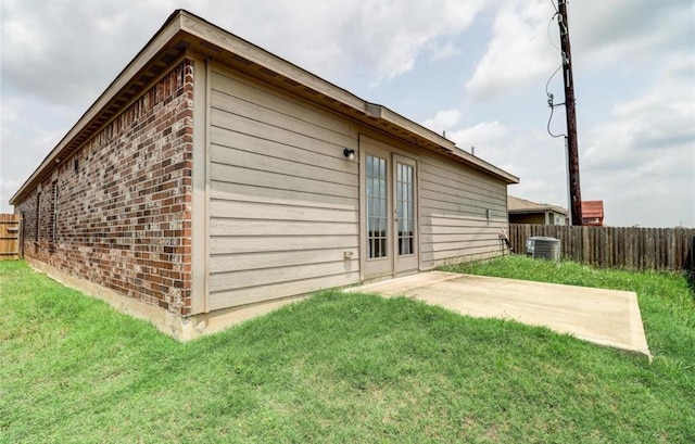 2037 Mule Rdg, Katy, TX 77493 - back of property featuring brick siding, central air condition unit, a patio area, and french doors