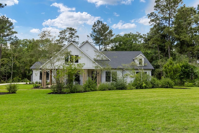 19720 Holly Creek Bnd, Magnolia, TX 77355 - modern farmhouse style home featuring a front lawn and board and batten siding