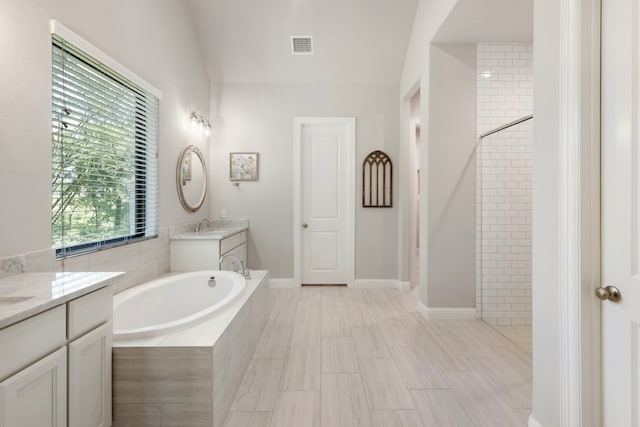 19720 Holly Creek Bnd, Magnolia, TX 77355 - bathroom featuring a bath and two vanities