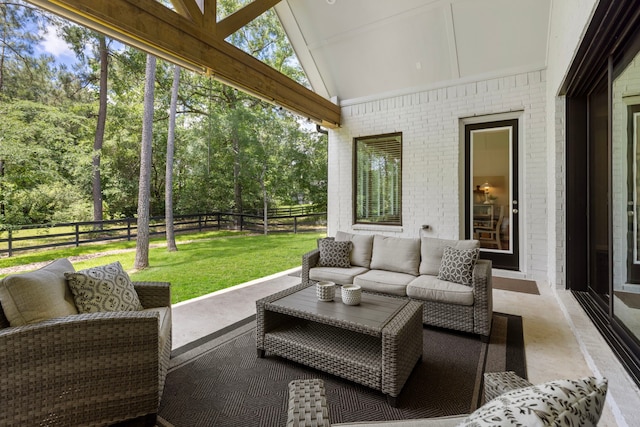 19720 Holly Creek Bnd, Magnolia, TX 77355 - sunroom featuring an outdoor living space, lofted ceiling, and view of wooded area