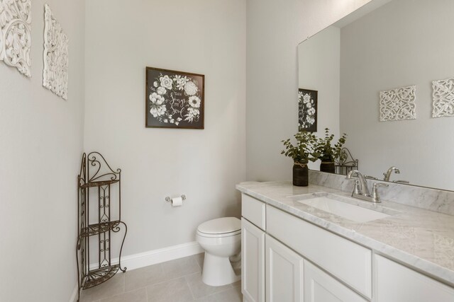 19720 Holly Creek Bnd, Magnolia, TX 77355 - bathroom featuring vanity, toilet, tile patterned floors, and baseboards