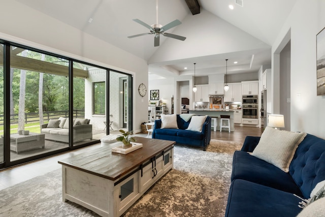 19720 Holly Creek Bnd, Magnolia, TX 77355 - living room featuring high vaulted ceiling, beamed ceiling, ceiling fan, and recessed lighting