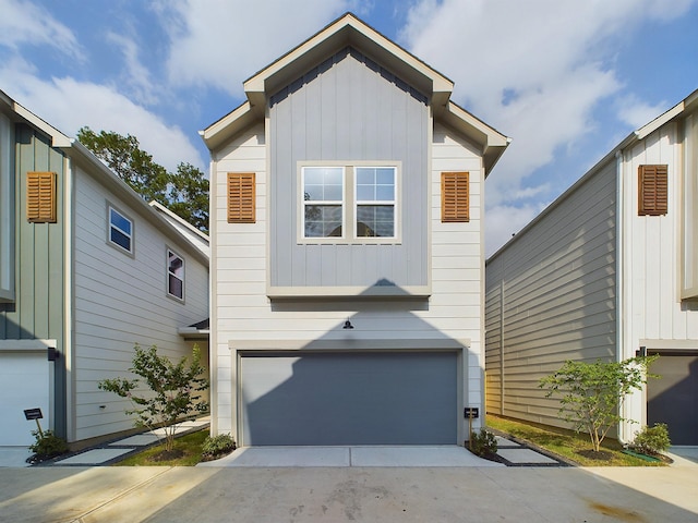 782 W Tidwell Rd Unit C, Houston, TX 77091 - view of front of property with board and batten siding, an attached garage, and driveway