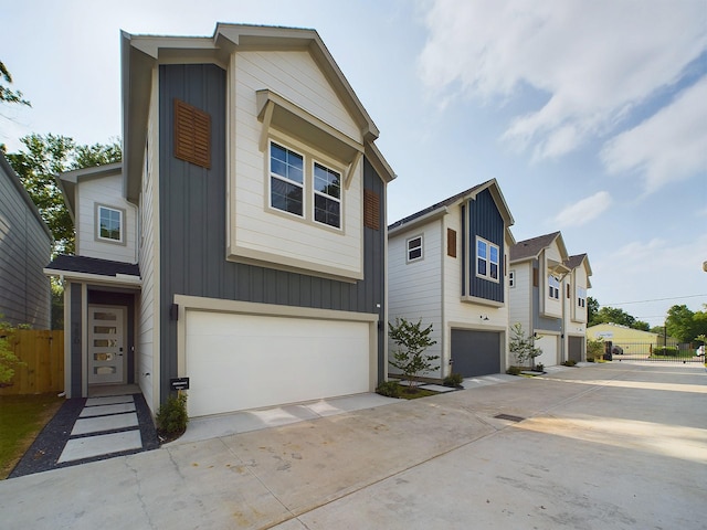 782 W Tidwell Rd Unit C, Houston, TX 77091 - view of front facade with a garage, driveway, and board and batten siding