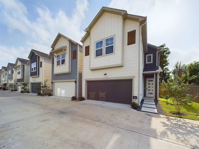 782 W Tidwell Rd Unit C, Houston, TX 77091 - view of property featuring a garage, board and batten siding, driveway, and a residential view