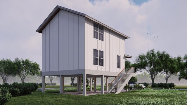 701 39th St, Galveston, TX 77550 - view of property exterior with stairs, board and batten siding, a yard, and a patio area