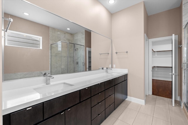3115 Leeland St, Houston, TX 77003 - bathroom with a shower stall, a spacious closet, double vanity, tile patterned flooring, and recessed lighting